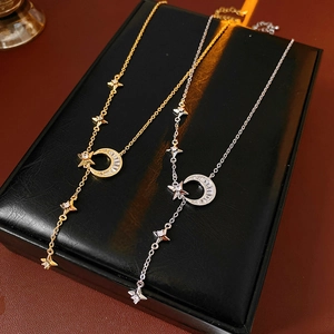 Detail of star and moon necklaces with sparkling zircon pendants in gold and silver finish
