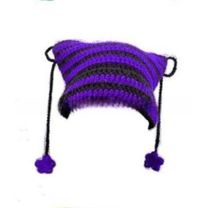 Detail of handmade striped knit hat with cat ears and purple flower tassel accents