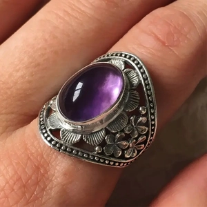 Bohemian silver ring featuring a large oval purple gemstone with vintage floral engravings