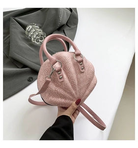Pink lace shell-shaped handbag with silver metal rings and detailed ruffle texture