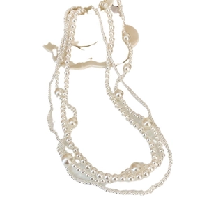 French vintage multilayer pearl necklace with cream white irregular pearls on white backdrop