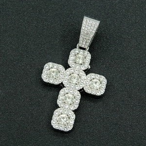 Macro shot of silver hip hop cross pendant with pave-set shimmering crystals