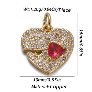 Macro view of a gold heart pendant with red zirconia and dimensions for jewelry DIY