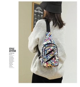 Close-up of nylon chest bag with colorful graffiti print and adjustable strap
