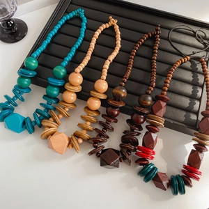 Detailed view of handmade wood bead necklaces in turquoise, brown and multicolor tones