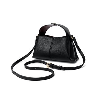 Close-up of black litchi pattern leather handbag with detachable adjustable shoulder strap
