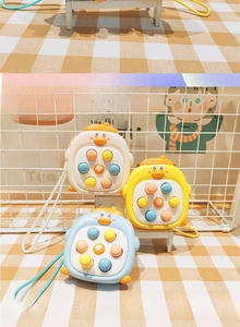 Three duck-shaped silicone fidget shoulder bags in white, yellow and blue for children