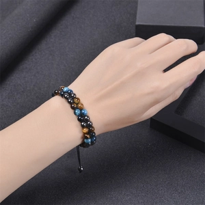 Detail of double-layer woven blue tiger eye stone and black magnetic bead bracelet