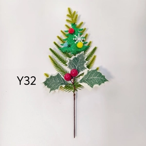 Detail of Christmas pick with pine needles, holly leaves, red berries and a glitter tree