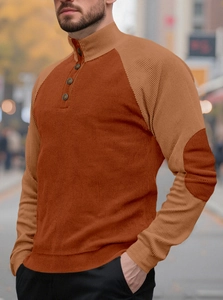 Detail of men's brick red corduroy henley sweatshirt with khaki contrast elbow patches