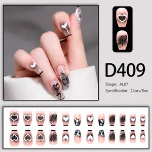 Macro detail of D409 pink french press-on nails with black gradient and heart motifs