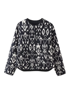 Detail view of bohemian print on a black and white quilted cotton jacket with pockets