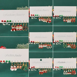 Detail view of colorful Christmas earring sets with Santa, reindeer and tree motifs