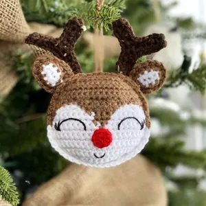 Detail of a handmade crochet reindeer ornament with knitted texture for Christmas tree decor