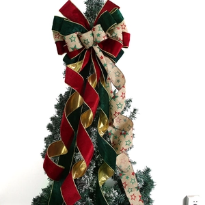 Festive Christmas tree topper bow with velvet ribbons and gold star patterns