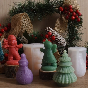 Detail of Christmas snowman and tree silicone molds with finished wax figurines