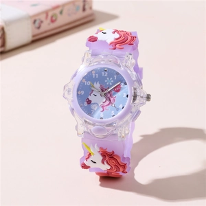 Close-up of kids glowing unicorn watch with purple silicone strap and 3D decorative charm