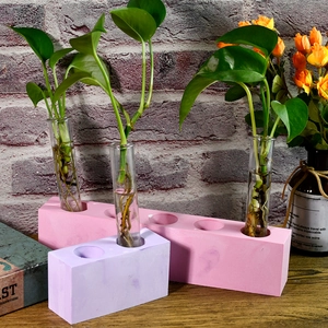 Détail du moule de vase DIY en résine avec tubes à essai et base mate sur bois