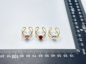 Three vintage 18K gold plated stainless steel rings with pink, red, and white stones