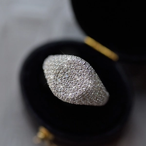 Macro shot of wide S925 silver ring band with pavé micro-set cubic zirconia in black box