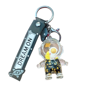 Astronaut liquid drift bottle keychain with gold stars and Dream On silicone strap