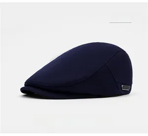 Detail of the navy blue knit texture and metal buckle on the flat ivy cap
