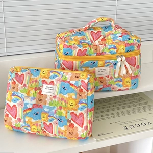 Quilted cotton toiletry bags with colorful graffiti patterns and yellow zippers