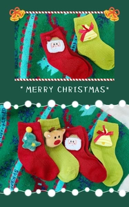 Detailed knit of Christmas socks with 3D Santa, reindeer and tree plush decorations