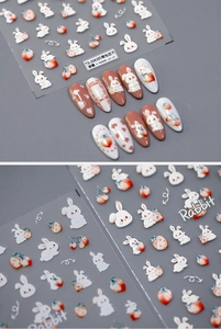 Detailed 3D relief nail stickers featuring white rabbits, strawberries, and hearts