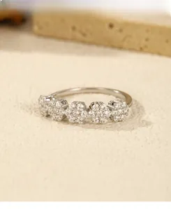 Detailed view of silver flower ring clusters with sparkling cubic zirconia pavé stones