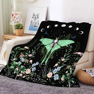 Black flannel blanket featuring a green Luna moth, moon phases, and colorful wildflowers