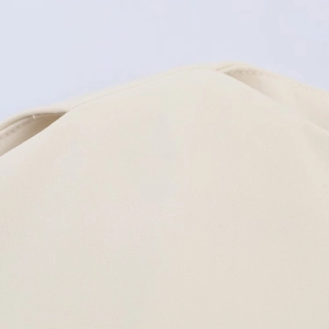 Detailed close-up of beige woven fabric showing fine texture and quality stitching