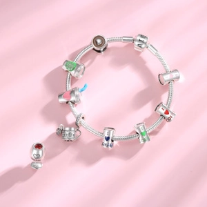 Detail of S925 silver coffee charms with colorful enamel on a pink background