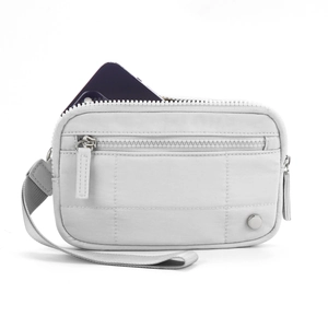 Macro view of white nylon card wallet showing texture, zipper detail and wrist strap