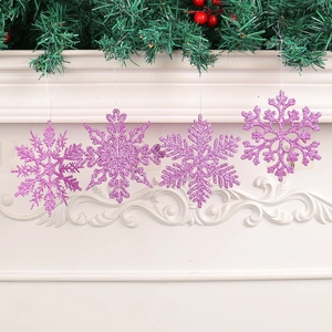 Four 10cm purple glitter snowflake ornaments displayed on a festive white mantel