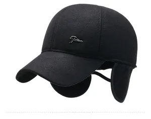 Side view of black wool winter baseball cap featuring fold-down ear flaps and metal logo