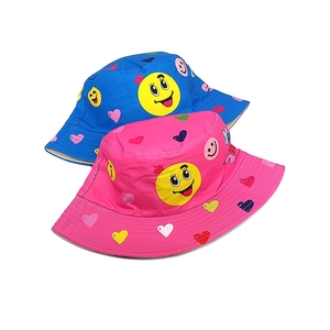 Kids reversible bucket hats in pink and blue with yellow smiley face and heart prints