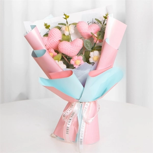 Handmade knitted heart and tulip flower bouquet wrapped in pink and blue paper