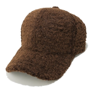 Detail of dark brown faux lamb wool baseball cap showing plush texture and curved brim