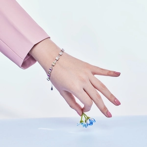 Detailed shot of S925 silver bracelet with pink and yellow square-cut colorful zircons