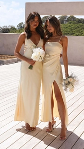 Detailed view of the silky cream satin fabric on a split-hem formal dress for women