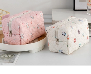Detail of quilted cotton makeup bags with cute bear prints and durable metal zipper