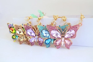 Set of 4 colorful rhinestone butterfly keychains in pink, blue, purple, and yellow tones