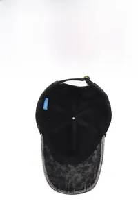 Detail view of cotton washed denim baseball cap featuring metal buckle and inner blue tag