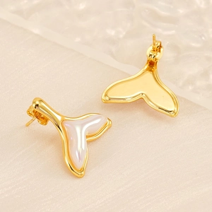 Detailed macro view of 18K gold plated fishtail stud earrings with pearly resin inlay