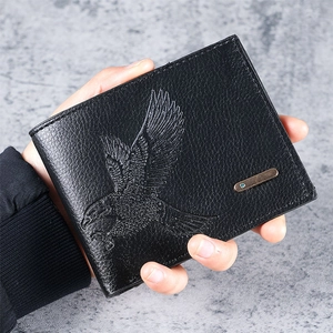 Detailed close-up of a men's black leather wallet featuring an eagle embossed pattern