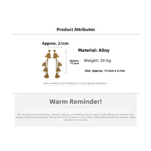 Detailed view of vintage gold tassel earrings with bell charms and measurement annotations