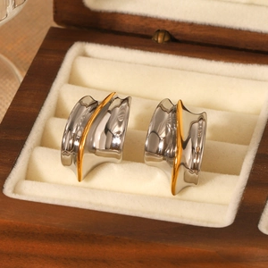 Two-tone gold and silver wave earrings with a polished mirror finish on jewelry box