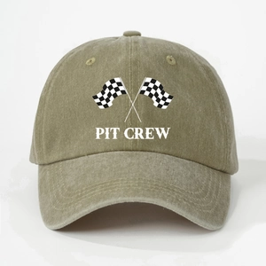 Detailed macro view of PIT CREW racing flags print on vintage washed khaki cotton cap