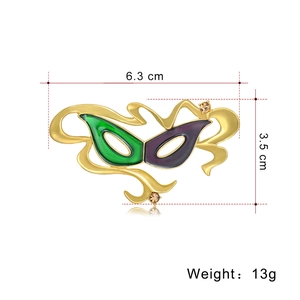 Golden mask brooch with green and purple enamel plus amber rhinestones, 6.3cm x 3.5cm